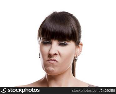 Close-up portrait of a lovely woman with a angry expression against white background