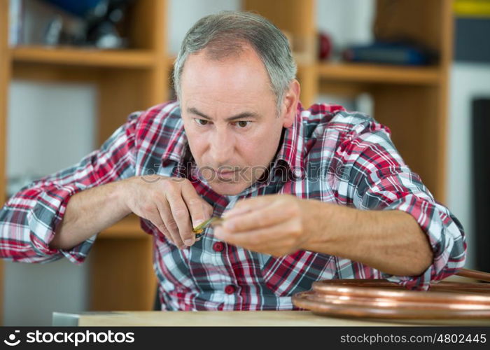 close up portrait of a middle-age watchmaker at work