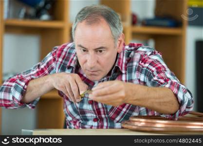 close up portrait of a middle-age watchmaker at work