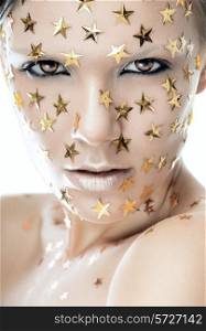 Close up portrait of a pretty woman with stars on face on a white background