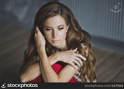 Close-up portrait of a slender long-haired girls.. The girl with brown hair hugging herself shoulders 6957.