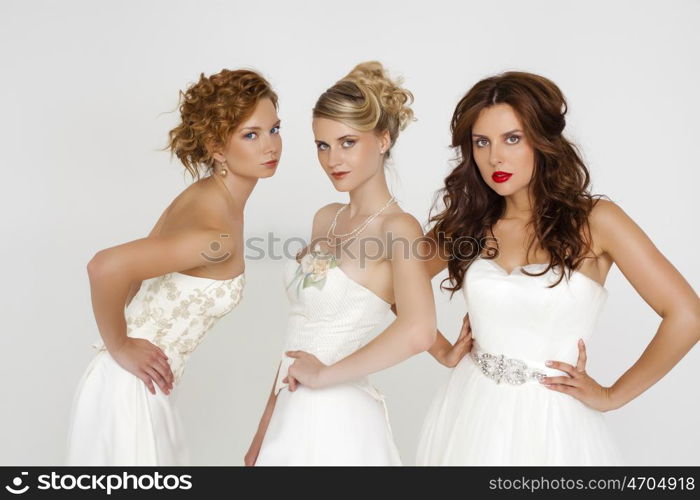 Close Up, Portrait of a three beautiful woman in wedding dress isolated over white background