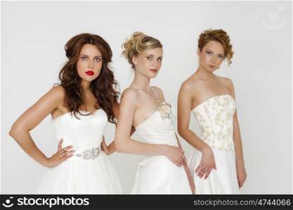 Close Up, Portrait of a three beautiful woman in wedding dress isolated over white background