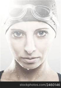 Close-up portrait of a young athletic swimer woman with googles and swimming cap