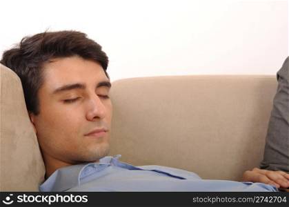 close-up portrait of an attractive young man sleeping on the couch (isolated on white background)