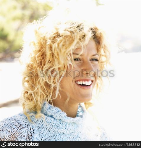 Close up portrait of attractive young blond woman smiling.