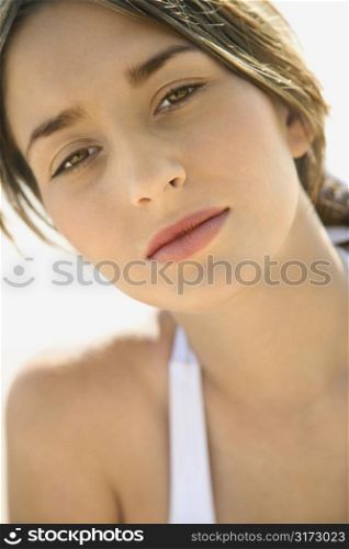 Close-up portrait of attractive young Caucasian woman looking at viewer.