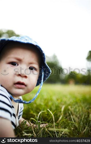 Close up portrait of baby boy looking at camera