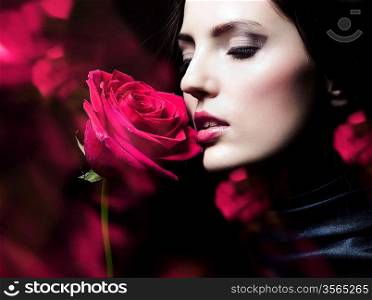 close-up portrait of beautiful brunette woman with red rose