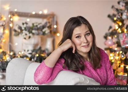Close-up portrait of beautiful girl on the background of sparkling lights.. Girl with a beautiful face a Christmas decorations 9494.