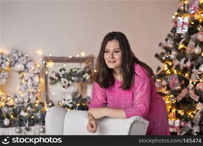 Close-up portrait of beautiful girl on the background of sparkling lights.. Girl with a beautiful face a Christmas decorations 9499.