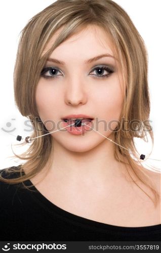 Close-up portrait of beautiful girl with a bead in her mouth