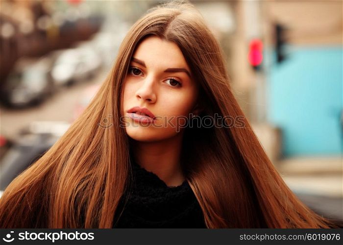 Close up portrait of beautiful girl with health long hair outdoors.