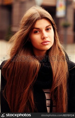 Close up portrait of beautiful girl with health long hair outdoors.