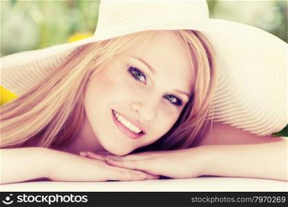 Close-up Portrait of Beautiful Smiling Young Woman in a White Hat Looking at Camera.
