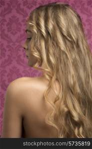 close-up portrait of beautiful woman with naked shoulders and cute long blonde wavy silky hair