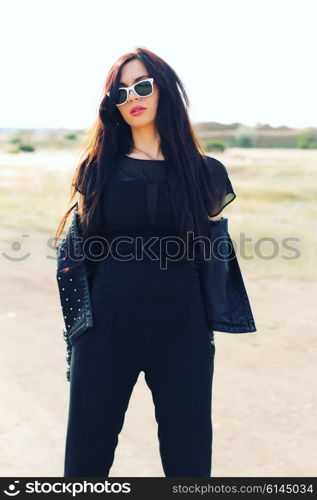 Close up portrait of beautiful woman with perfect long hairs, wearing stylish leather black jacket. Autumn retro style.