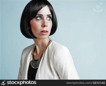 Close up portrait of beautiful young woman wearing white jacket - studio shot
