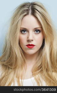 Close-up portrait of beautiful young woman with blond hair and red lips