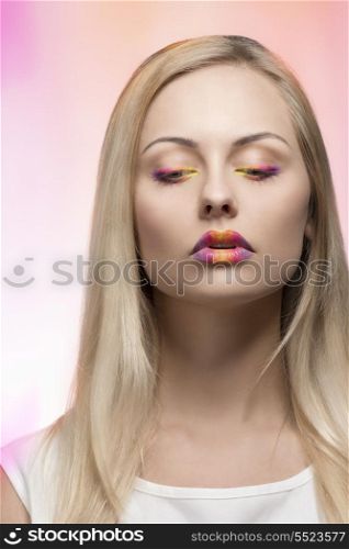close-up portrait of beauty woman with spring multicolor make-up, blonde smooth hair and white dress