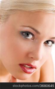 close up portrait of blond cute woman in a beauty shot looking in camera