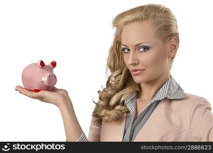 close-up portrait of blonde girl with business suit and curly hair-style taking pink piggybank in the hand and looking in the camera