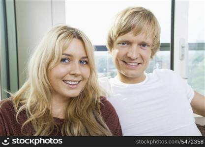 Close-up portrait of blue eyed smiling couple at home