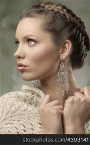 close-up portrait of charming woman with splendid eyes, elegant hair-style, precious earrings and wool shawl