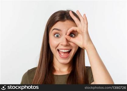 Close up portrait of cheerful, cute, stylish,attractive, trendy girl making binoculars with fingers, isolated on grey background, having good mood.. Close up portrait of cheerful, cute, stylish,attractive, trendy girl making binoculars with fingers, isolated on grey background, having good mood