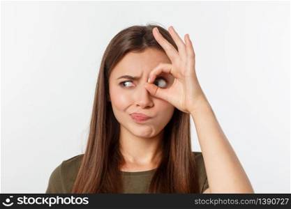 Close up portrait of cheerful, cute, stylish,attractive, trendy girl making binoculars with fingers, isolated on grey background, having good mood.. Close up portrait of cheerful, cute, stylish,attractive, trendy girl making binoculars with fingers, isolated on grey background, having good mood