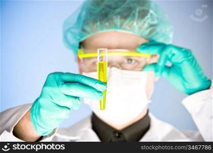 close up portrait of chemist, focus on the test tube