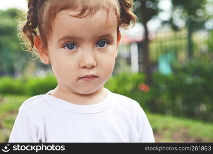 Close up Portrait of cute baby girl in the park.