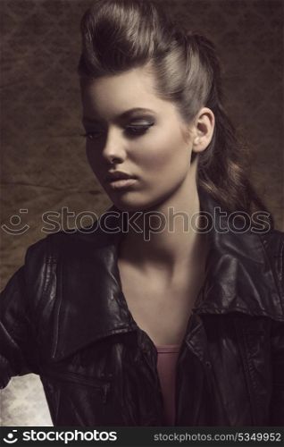 close-up portrait of cute brunette lady with dark style posing with modern curly hair-style and leather jacket