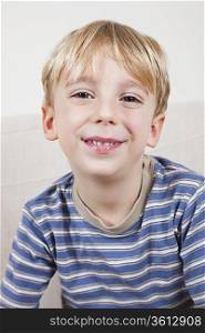 Close-up portrait of cute young boy smiling