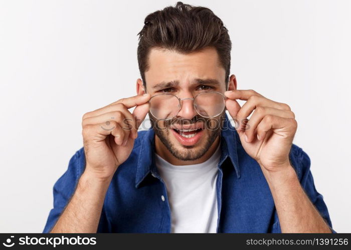 Close up portrait of disappointed stressed bearded young man in shirt over white background. Close up portrait of disappointed stressed bearded young man in shirt over white background.