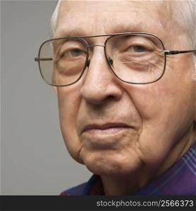 Close-up portrait of elderly man in glasses.