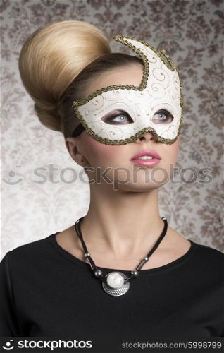 close-up portrait of elegant woman with classic blonde hair-style, necklace and cute decorated mask. Mysterious beautiful woman