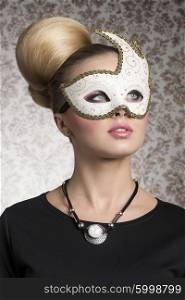 close-up portrait of elegant woman with classic blonde hair-style, necklace and cute decorated mask. Mysterious beautiful woman