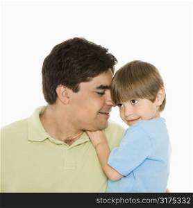 Close up portrait of father holding son against white background.