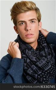 Close-up portrait of handsome blonde man wearing scarf