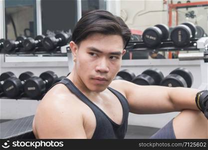 Close-up portrait of handsome muscular man in gym