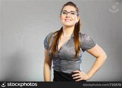 Close up portrait of happy business woman wearing eyeglasses and grey shirt.. Happy business woman wearing eyeglasses and shirt