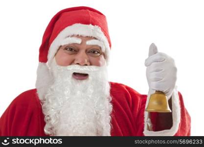 Close-up portrait of happy Santa Claus with bell against white background