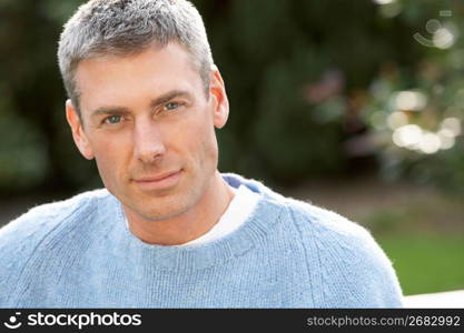 Close Up Portrait Of Man Standing Outside In Autumn Landscape