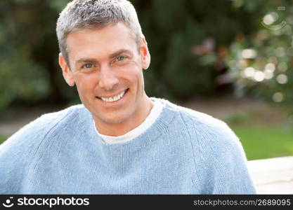 Close Up Portrait Of Man Standing Outside In Autumn Landscape