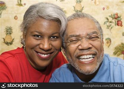 Close up portrait of mature African American couple smiling at viewer.