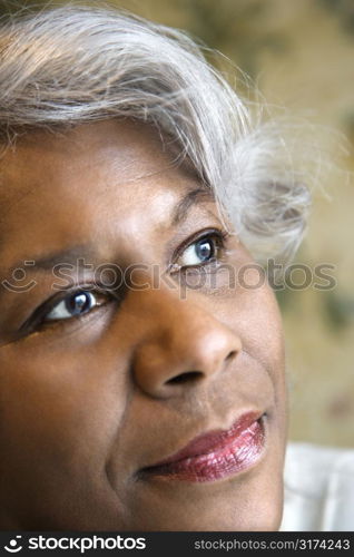 Close up portrait of mature African American woman looking to the side.