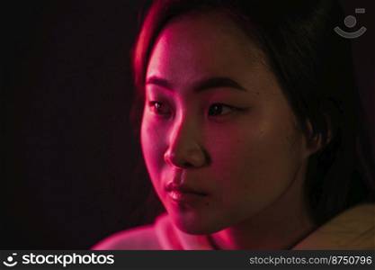 Close up portrait of millennial pretty korean woman with long hairstyle with neon light. Hipster teenager in studio.. Close up portrait of millennial pretty korean woman with long hairstyle with neon light. Hipster teenager in studio