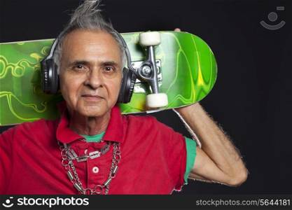 Close-up portrait of old man with skateboard