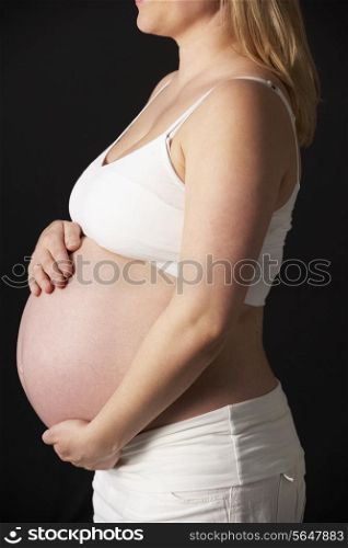 Close Up Portrait Of Pregnant Woman On Black Background